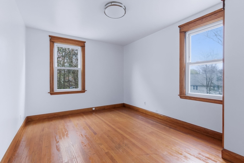 7 3rd Avenue Dudley, MA 01571 - Photo 9 of 42 a view of an empty room with wooden floor and a window