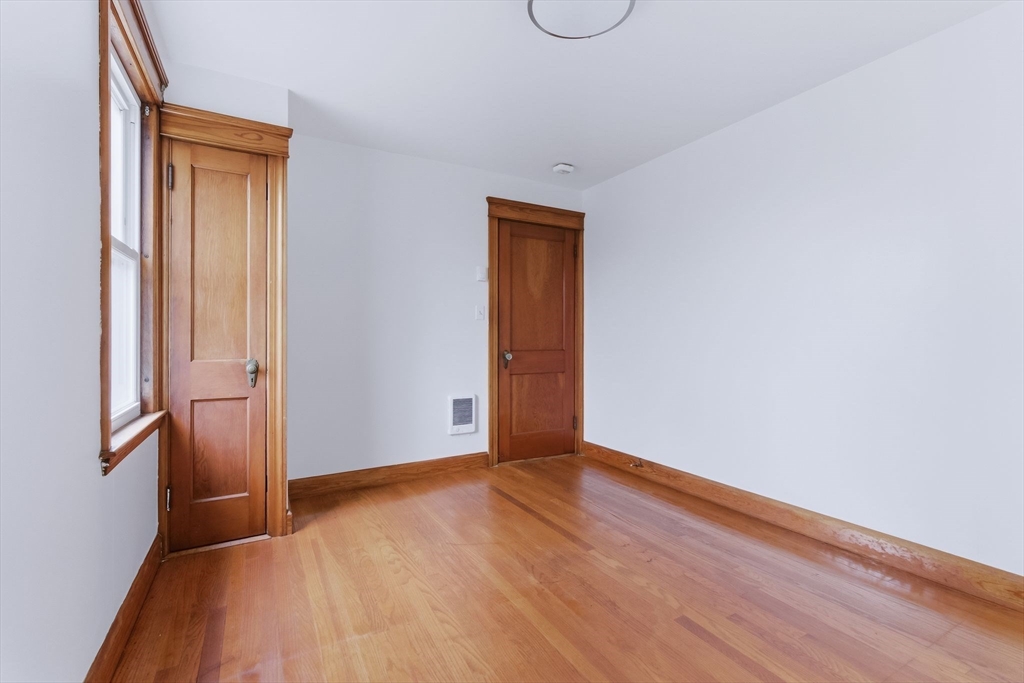 7 3rd Avenue Dudley, MA 01571 - Photo 10 of 42 a view of an empty room with wooden floor and a window