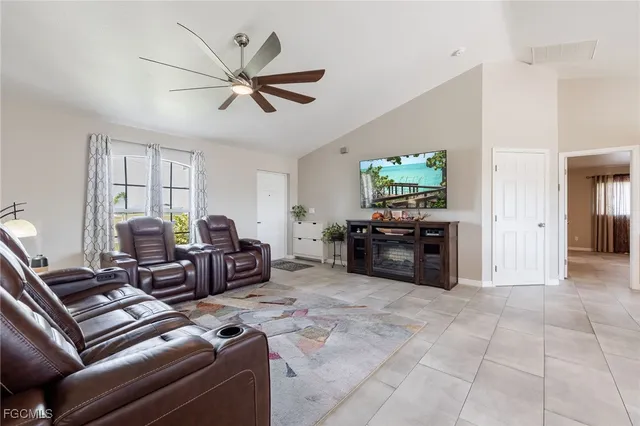 a living room with furniture a ceiling fan and a window