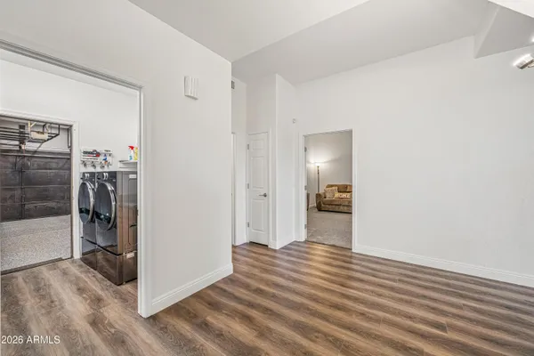 a view of a hallway with wooden floor and closet