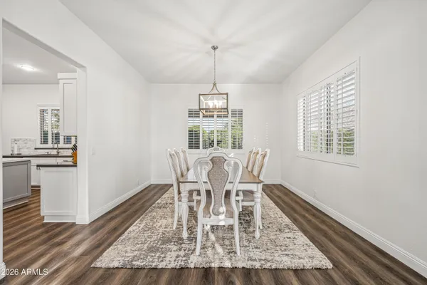 a dining room with furniture a rug and wooden floor