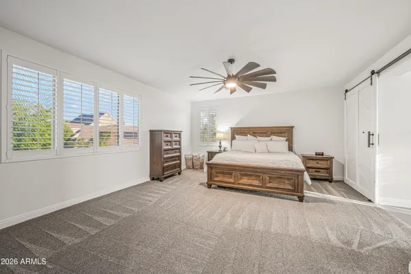 a spacious bedroom with a bed and window