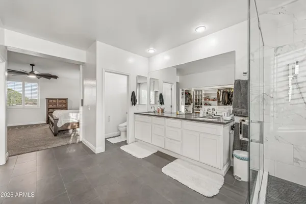 a kitchen with white cabinets and refrigerator