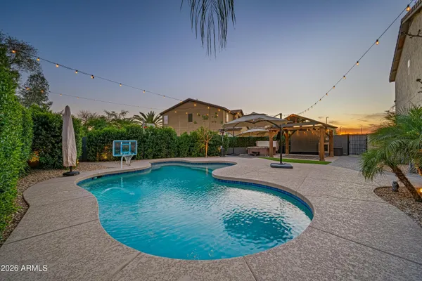 a swimming pool with outdoor seating yard and plants