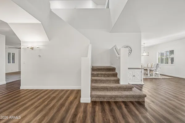 a view of entryway and hall with wooden floor