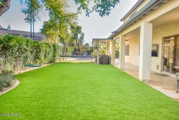 a view of house with backyard porch and sitting area