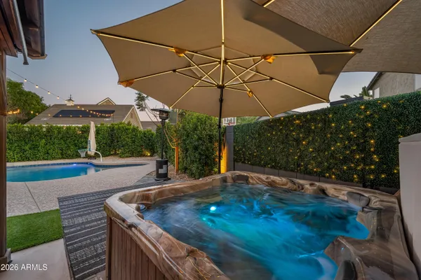 a view of a patio with a table and chairs under an umbrella