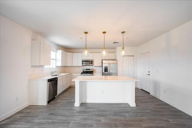 a view of a hallway with a ceiling fan