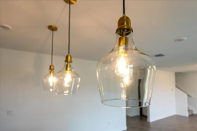 a large kitchen with kitchen island a stove a sink a refrigerator and a countertop with wooden floor