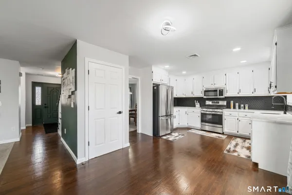 a kitchen with stainless steel appliances refrigerator stove top oven and cabinets