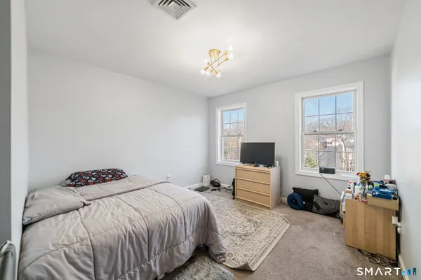 a bedroom with a bed and a couch