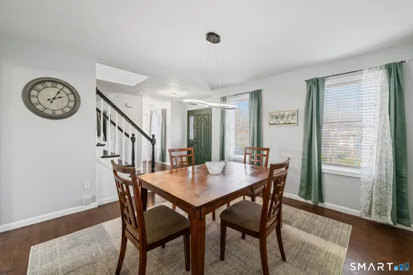 a view of a dining room with furniture and a large window