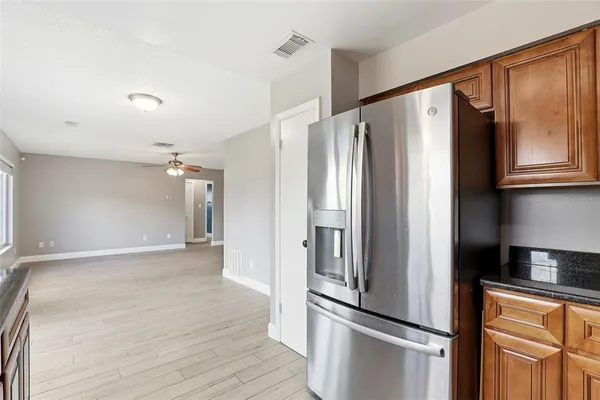 a kitchen with stainless steel appliances a refrigerator and cabinets