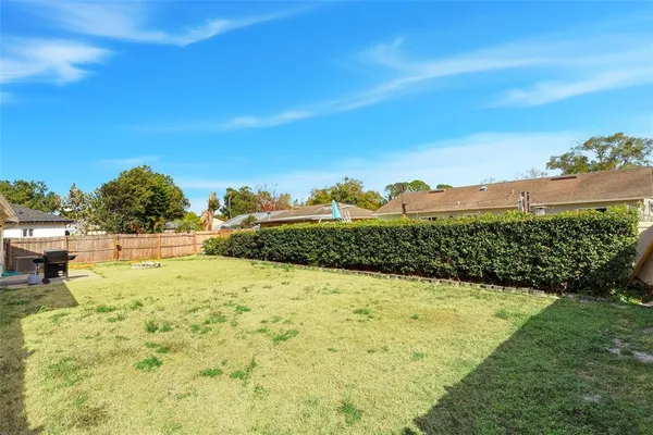 a view of a house with a backyard