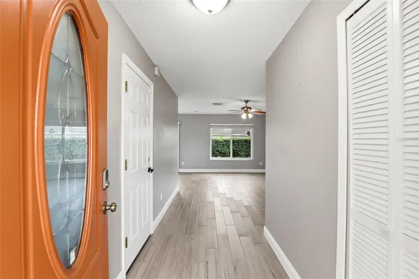 a view of a bedroom with wooden floor and windows
