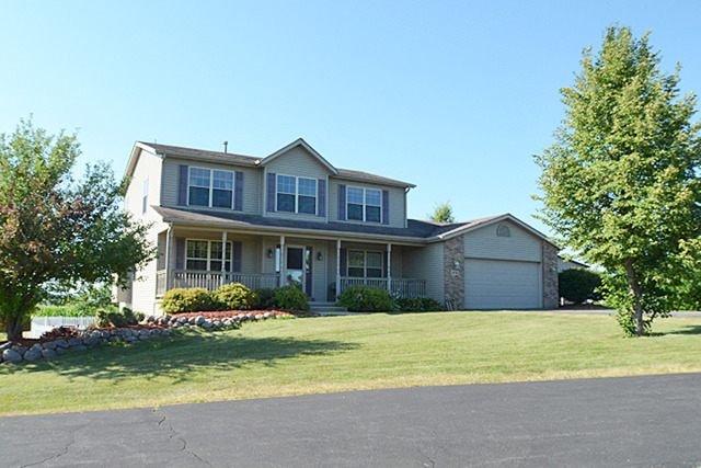 16732 Trask Bridge Road Pecatonica, IL 61063 - Photo 1 of 17 a front view of a house with a yard and large trees