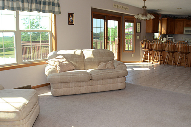 16732 Trask Bridge Road Pecatonica, IL 61063 - Photo 9 of 17 a living room with furniture and a floor to ceiling window