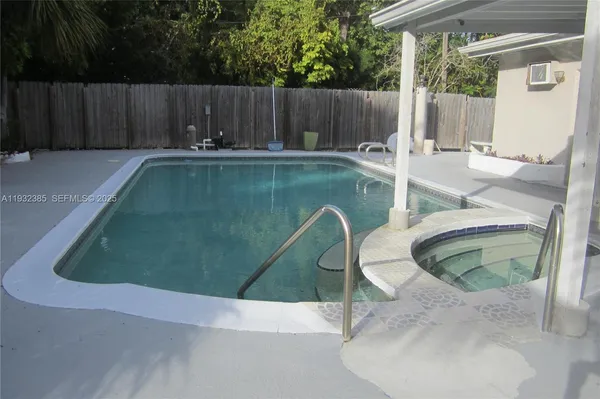 a backyard of a house with table and chairs