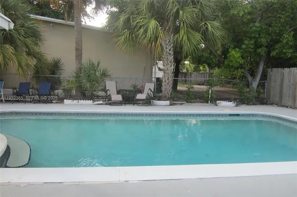 a backyard of a house with table and chairs