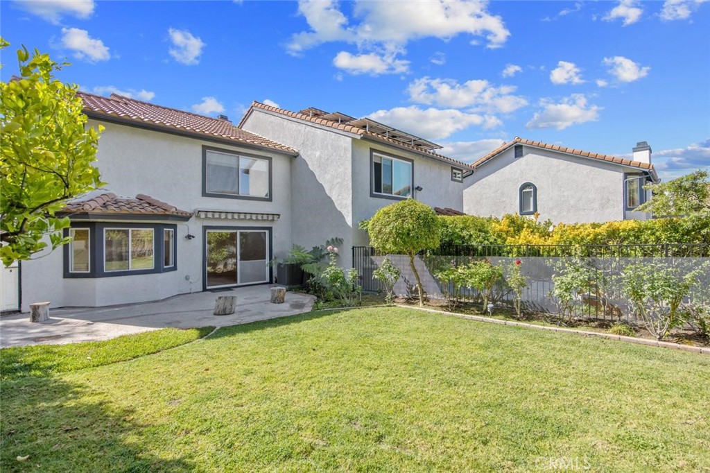 5974 Ruthwood Drive Calabasas, CA 91302 - Photo 23 of 30 a front view of a house with a yard and garage