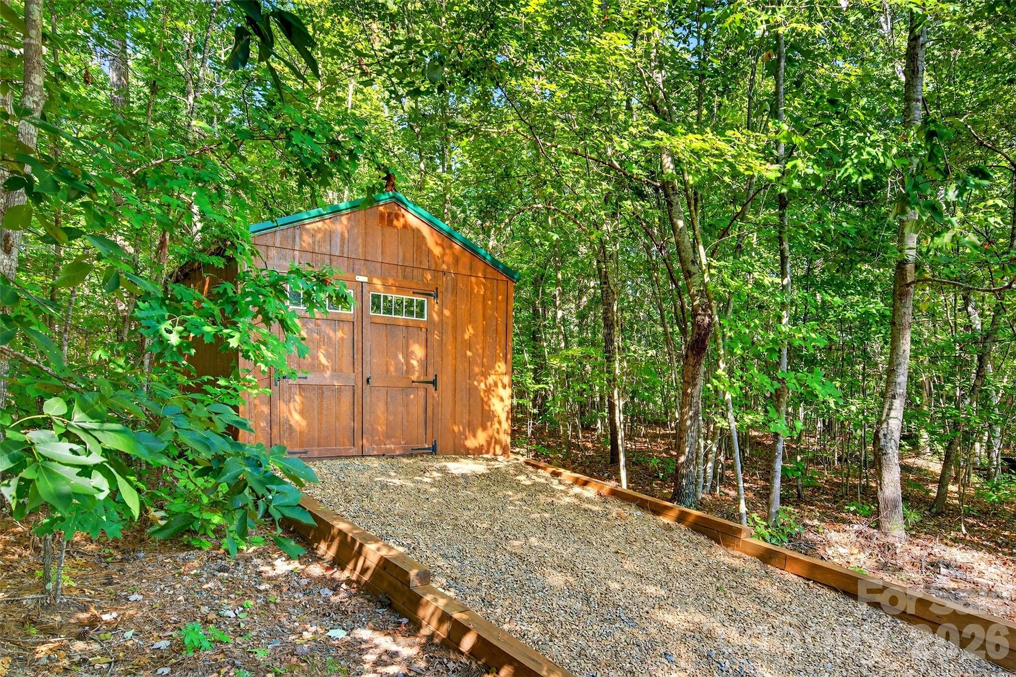 61 Majestic Path Nebo, NC 28761 - Photo 38 of 48 a backyard of a house with large trees and plants