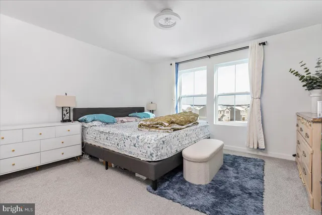 a bedroom with a large bed and a dresser