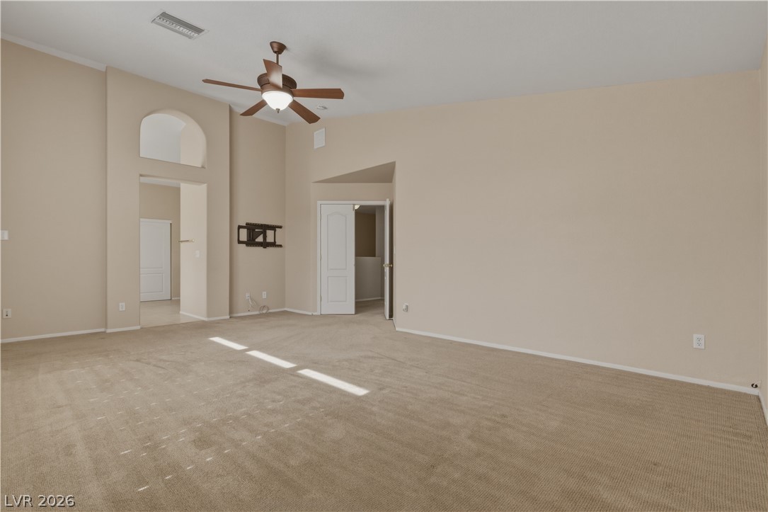 29 Olive Tree Henderson, NV 89074 - Photo 30 of 60 This expansive room offers comfortable carpeting, arched doorways, and a ceiling fan for year-round comfort.