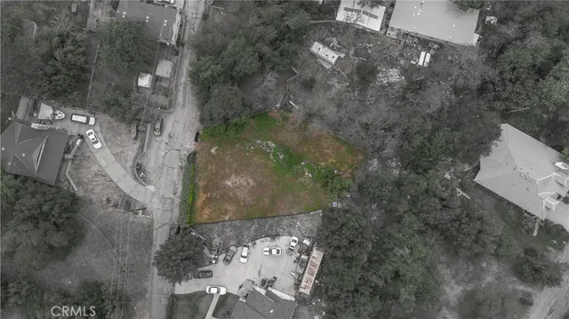 a backyard of a house with lots of green space and plants