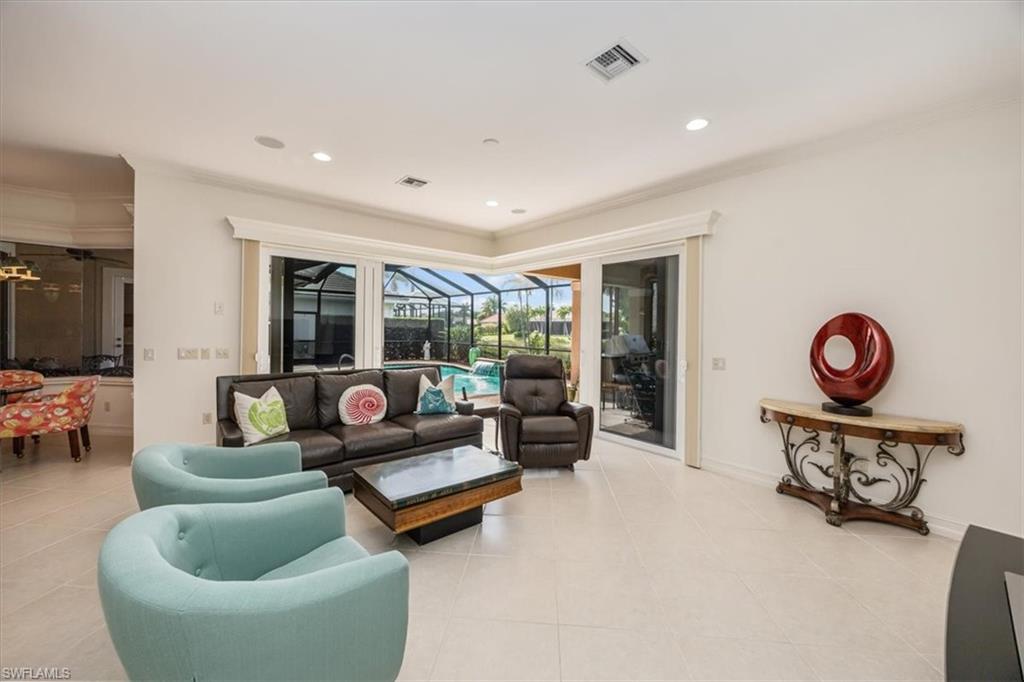 4971 Rustic Oaks Circle Naples, FL 34105 - Photo 11 of 50 a living room with furniture and a large window