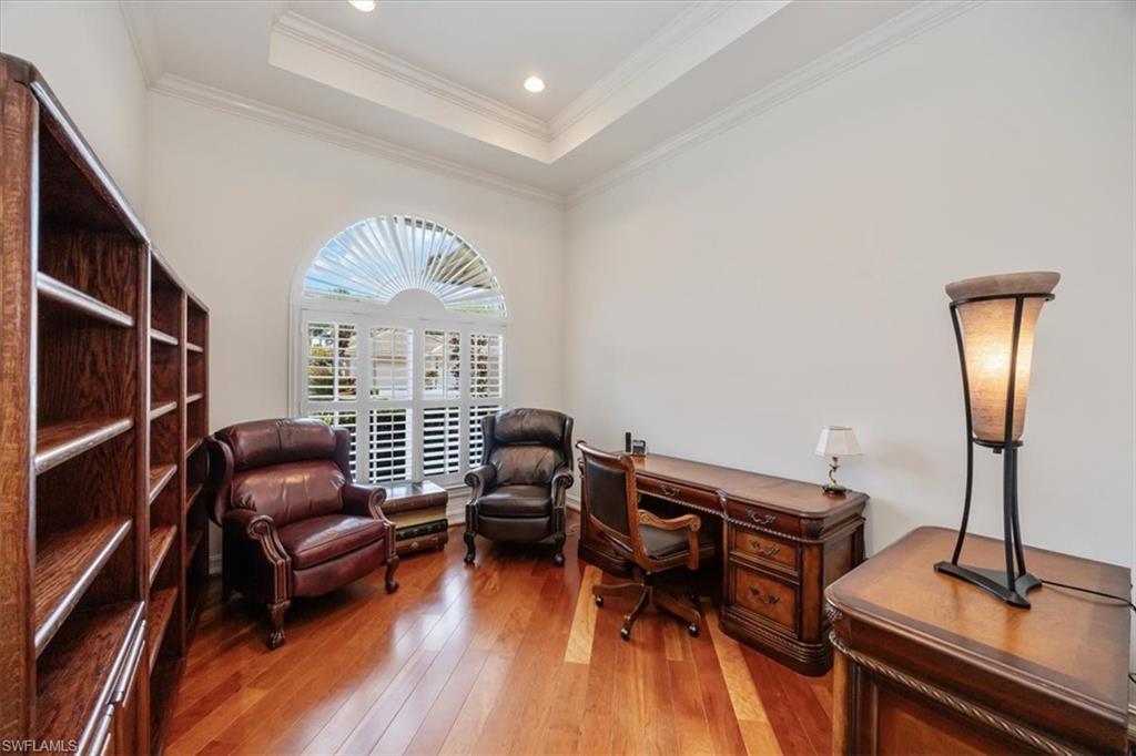 4971 Rustic Oaks Circle Naples, FL 34105 - Photo 18 of 50 a living room with furniture a window and wooden floor