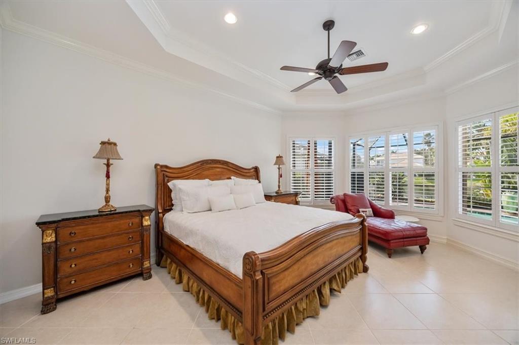 4971 Rustic Oaks Circle Naples, FL 34105 - Photo 20 of 50 a bedroom with a bed and window