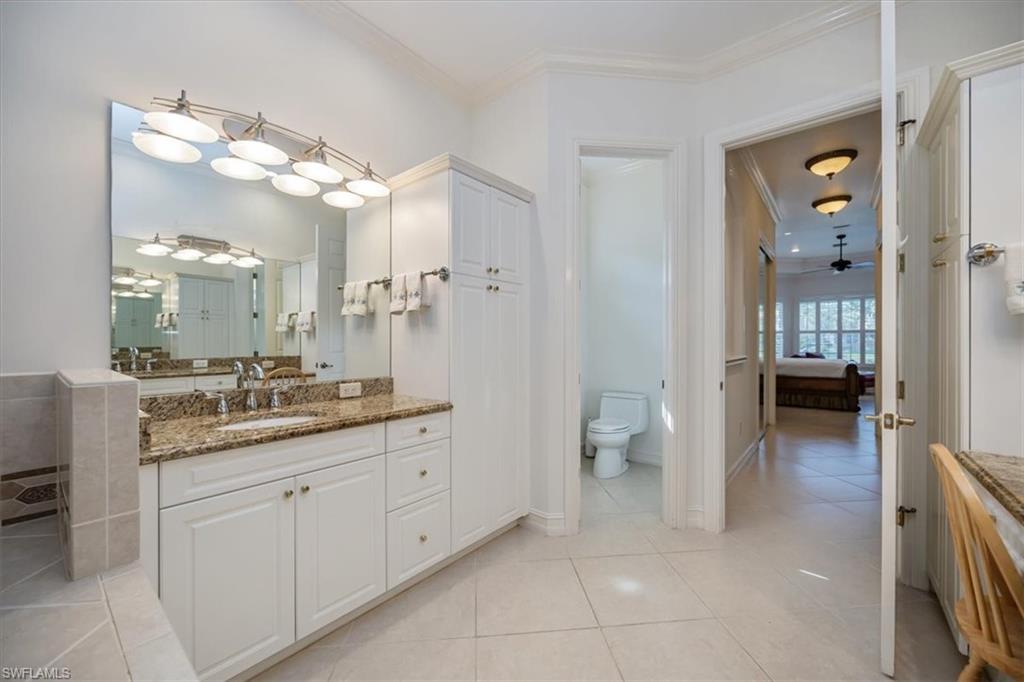 4971 Rustic Oaks Circle Naples, FL 34105 - Photo 23 of 50 a bathroom with a granite countertop sink mirror and toilet