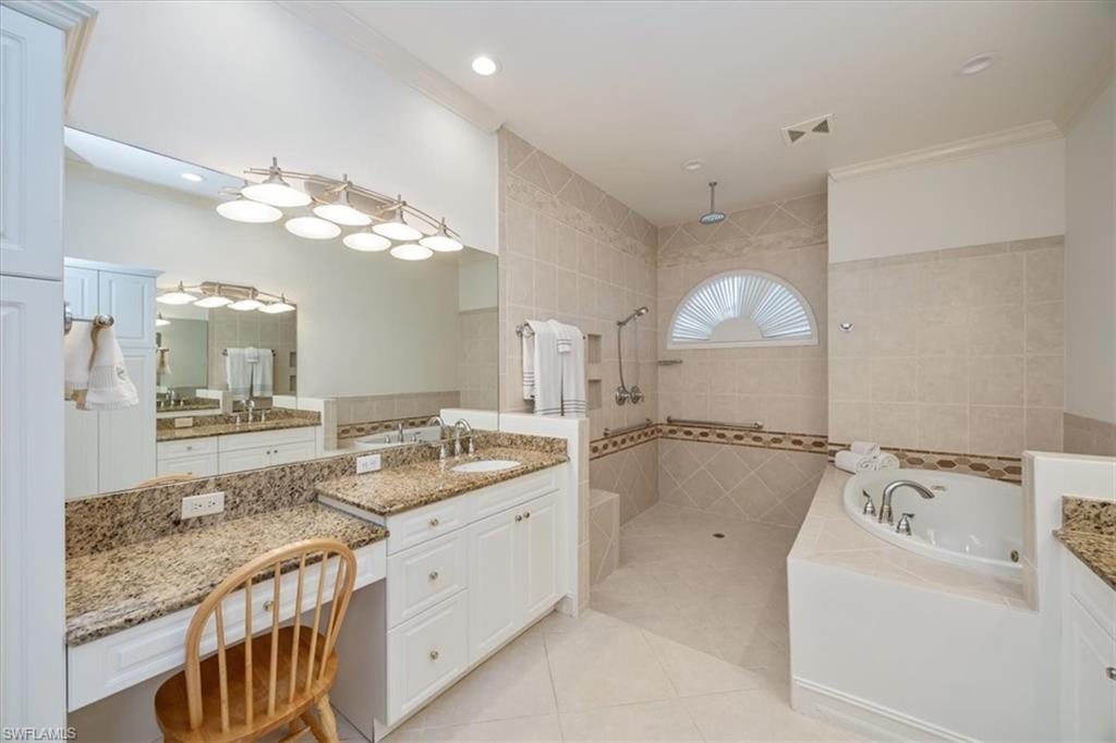 4971 Rustic Oaks Circle Naples, FL 34105 - Photo 24 of 50 a bathroom with a granite countertop sink a large mirror and a shower