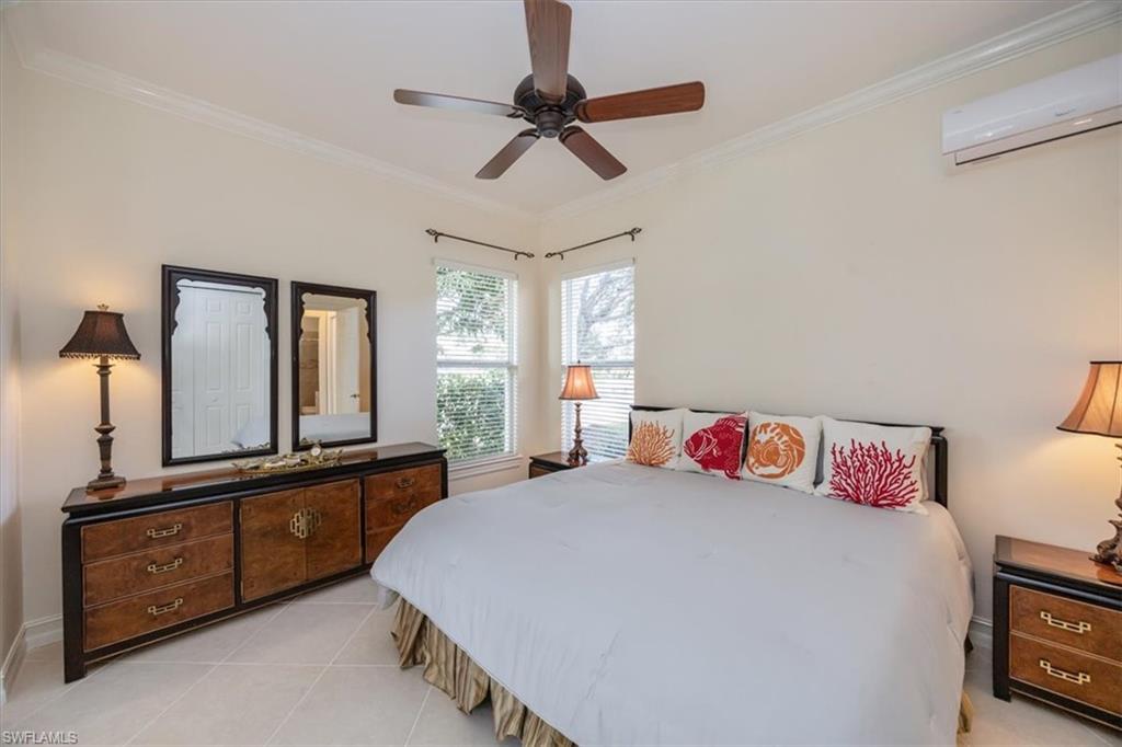 4971 Rustic Oaks Circle Naples, FL 34105 - Photo 27 of 50 a bedroom with a bed dresser and a window
