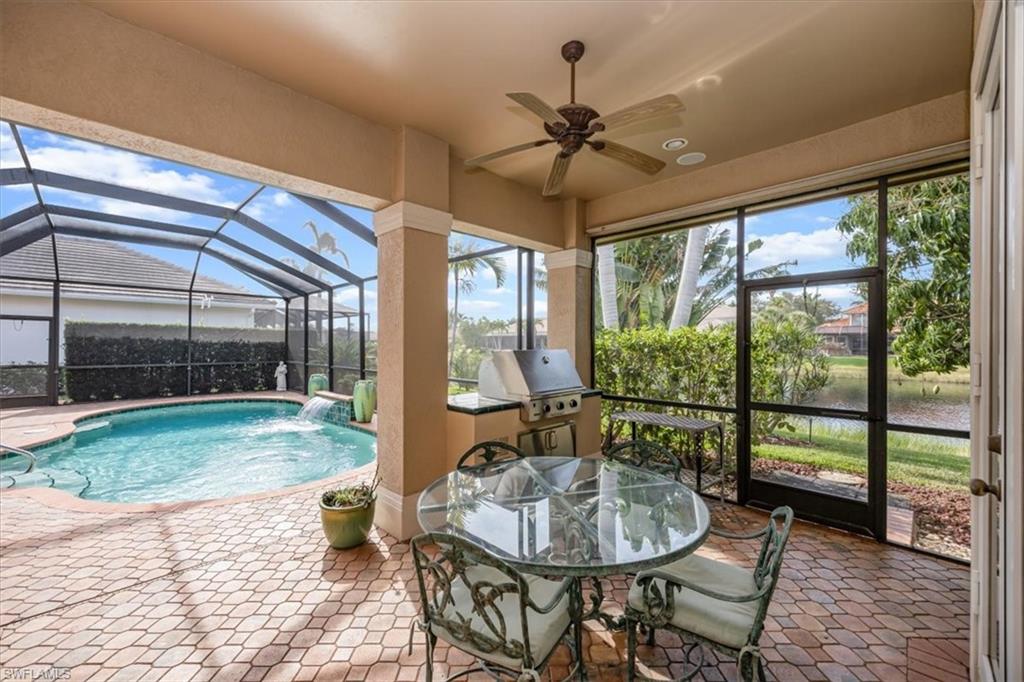 4971 Rustic Oaks Circle Naples, FL 34105 - Photo 39 of 50 a living room with furniture and a large window