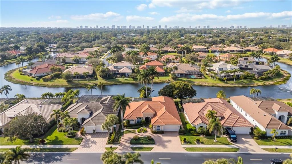4971 Rustic Oaks Circle Naples, FL 34105 - Photo 4 of 50 an aerial view of residential houses with outdoor space and parking
