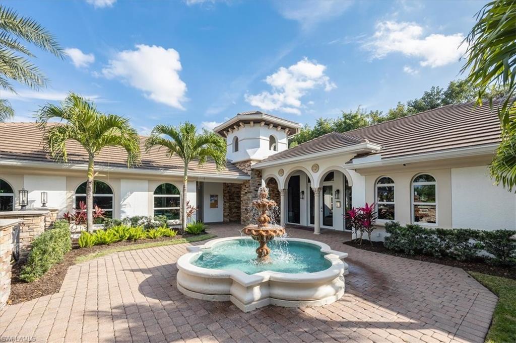 4971 Rustic Oaks Circle Naples, FL 34105 - Photo 44 of 50 a front view of a house with garden and patio