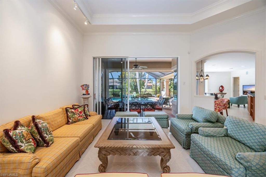 4971 Rustic Oaks Circle Naples, FL 34105 - Photo 9 of 50 a living room with furniture and a large window