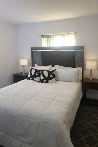 a bedroom with a bed and window