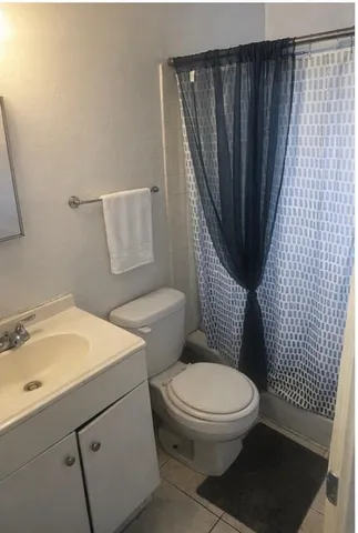 a white toilet sitting next to a bathroom sink