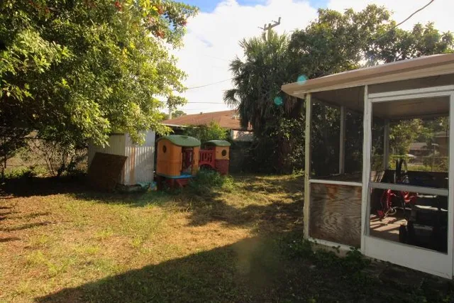 a backyard of a house with yard and outdoor seating