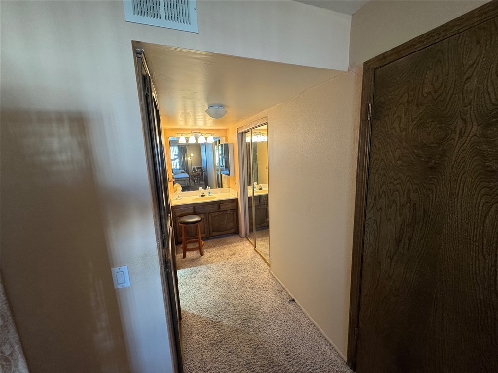 1190 Ramar Road, Unit 15 Bullhead City, AZ 86442 - Photo 11 of 17 Corridor featuring light colored carpet