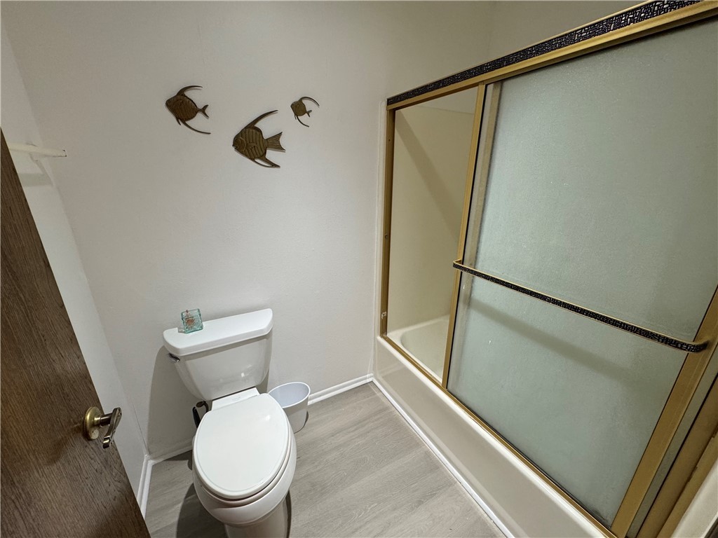 1190 Ramar Road, Unit 15 Bullhead City, AZ 86442 - Photo 14 of 17 Bathroom featuring wood finished floors and combined bath / shower with glass door