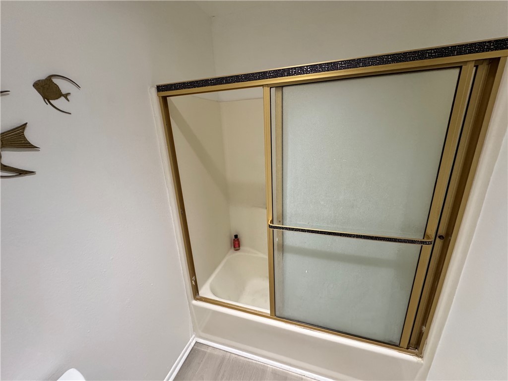 1190 Ramar Road, Unit 15 Bullhead City, AZ 86442 - Photo 15 of 17 Bathroom with combined bath / shower with glass door and baseboards