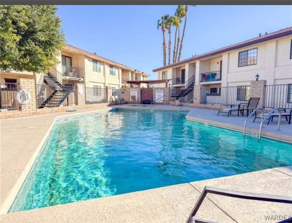 1190 Ramar Road, Unit 15 Bullhead City, AZ 86442 - Photo 16 of 17 Community pool with stairway, a balcony, and a patio area