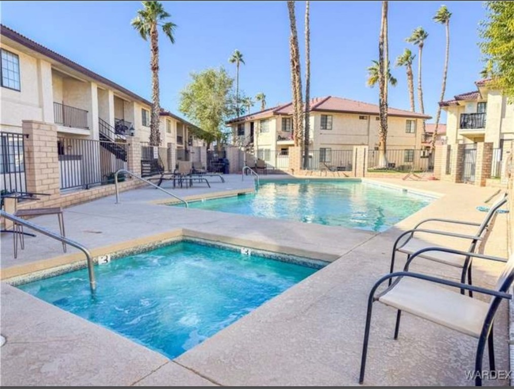 1190 Ramar Road, Unit 15 Bullhead City, AZ 86442 - Photo 17 of 17 Community pool featuring a patio, a community hot tub, and a residential view