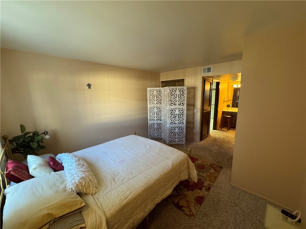 1190 Ramar Road, Unit 15 Bullhead City, AZ 86442 - Photo 9 of 17 Bedroom featuring carpet and ensuite bathroom