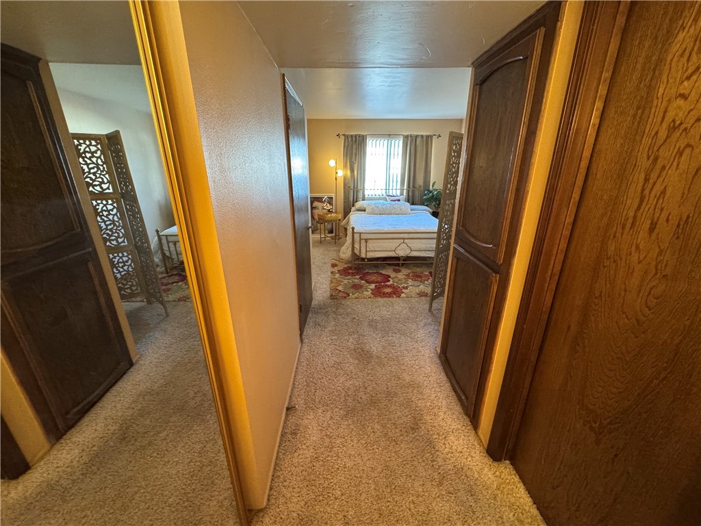 1190 Ramar Road, Unit 15 Bullhead City, AZ 86442 - Photo 10 of 17 Hallway featuring light colored carpet and a textured wall