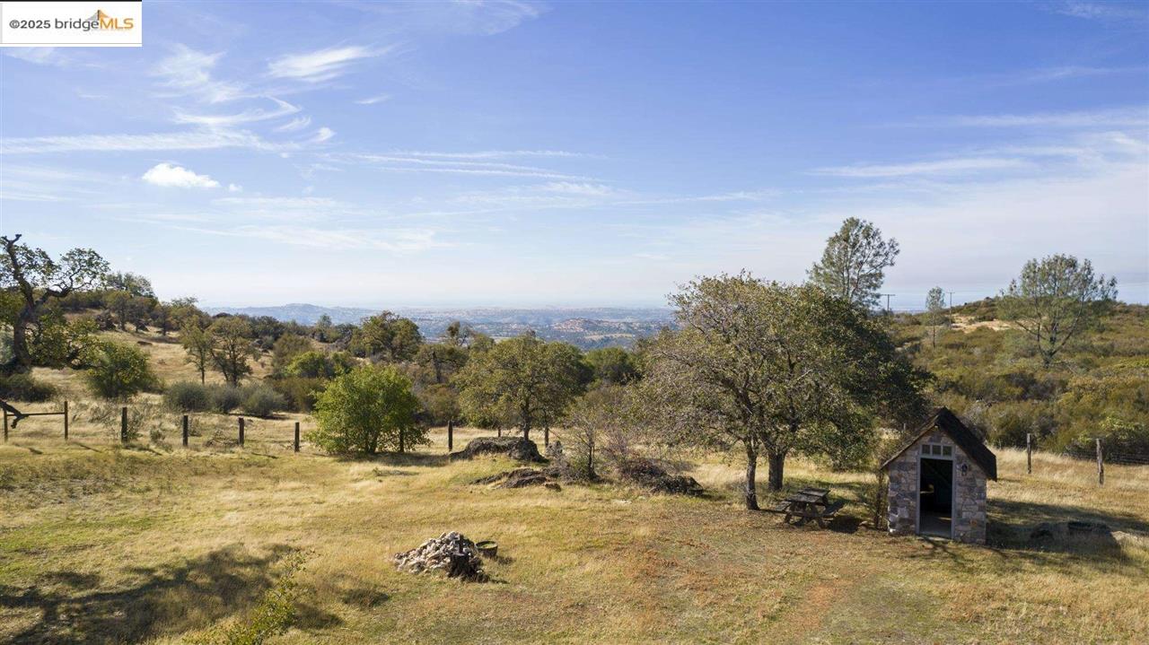 16101 Moccasin Ranch Road Coulterville, CA 95311 - Photo 40 of 60 a view of a yard with trees in the background