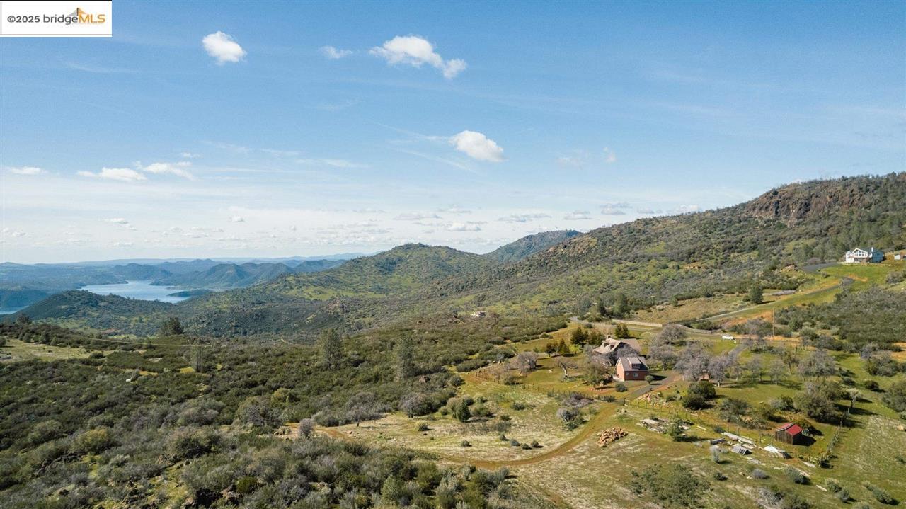 16101 Moccasin Ranch Road Coulterville, CA 95311 - Photo 53 of 60 a view of a dry yard with mountains in the background